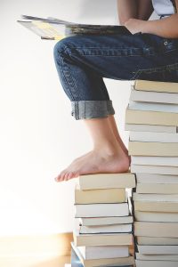 Woman with feet on books