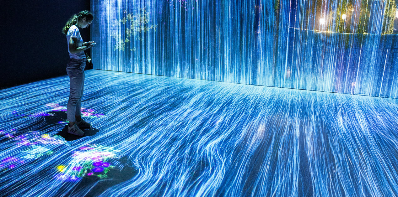 Woman looks at phone in a blue flow of digital data