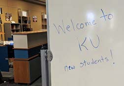 A whiteboard saying Welcome to KU new students!
