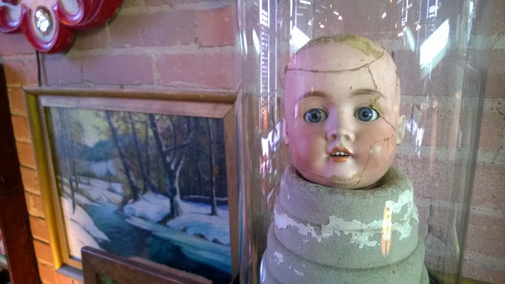 A doll head in a container 