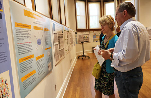 Krzysztof Kuczera and Mary Lee Hummert looking at a poster