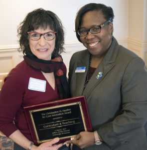 Reva Friedman and DeAngela Burns-Wallace holding an award together