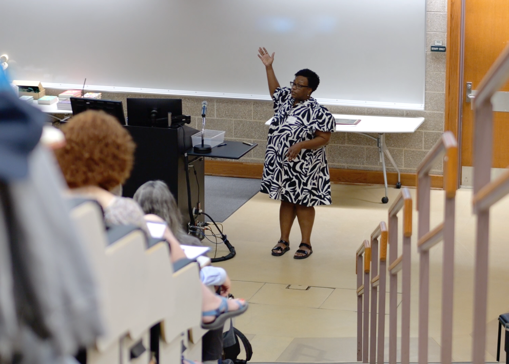 Keynote speaker Beronda Montgomery speaking at the front of a lecture hall at KU.
