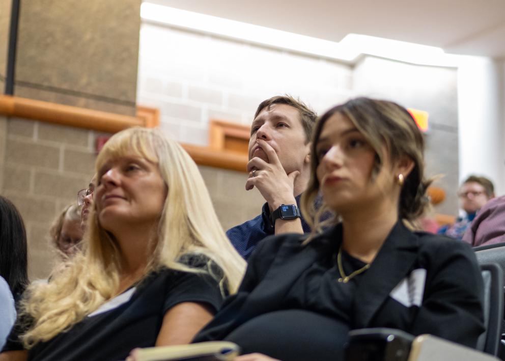 KU faculty members sitting listening to keynote speaker