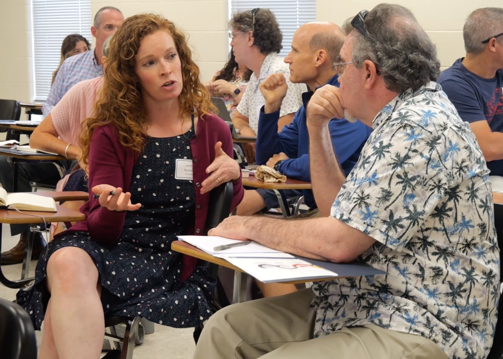 KU faculty discussing a topic during Teaching Summit workshop.