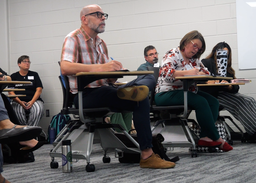 KU faculty taking notes during Teaching Summit workshop.