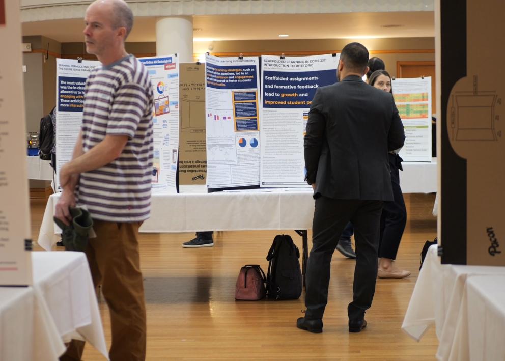 People looking at academic posters